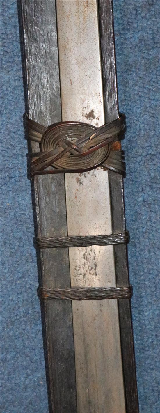 A Naga Dao sword and hardwood scabbard, Assam. 19th century, total length 114.5cm (45in.)